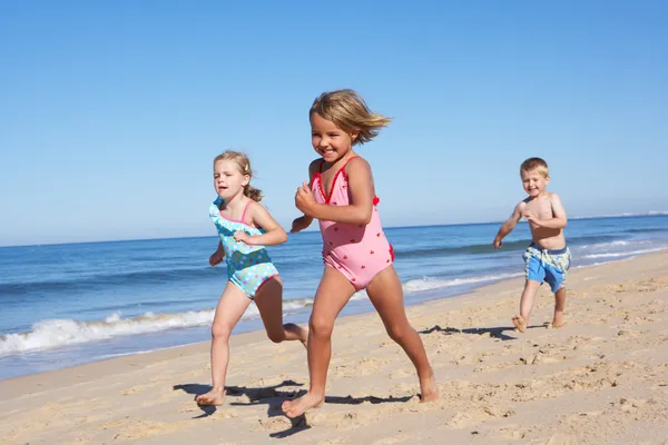 Трое детей, идущую вдоль пляжа — стоковое фото