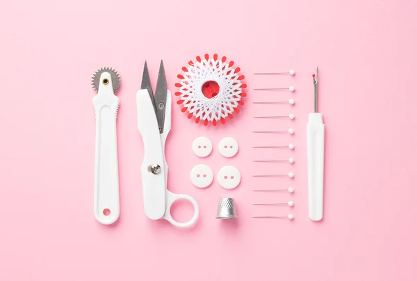 Швейные инструменты над розовый — стоковое фото