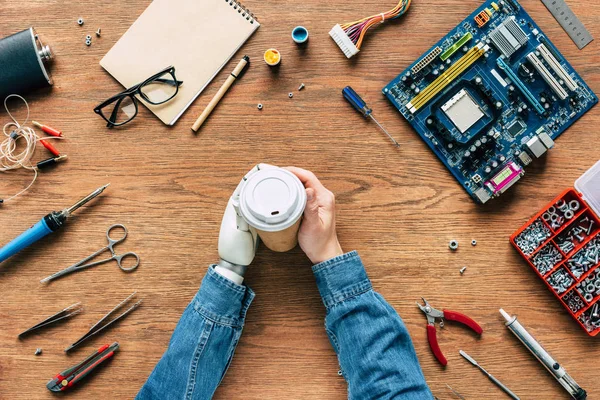 Cropped Image Electronic Engineer Prosthetic Arm Holding Paper Cup Table — стоковое фото